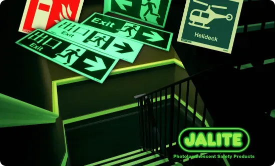 Jalite photoluminescent exit and safety signs glowing in a dark stairwell